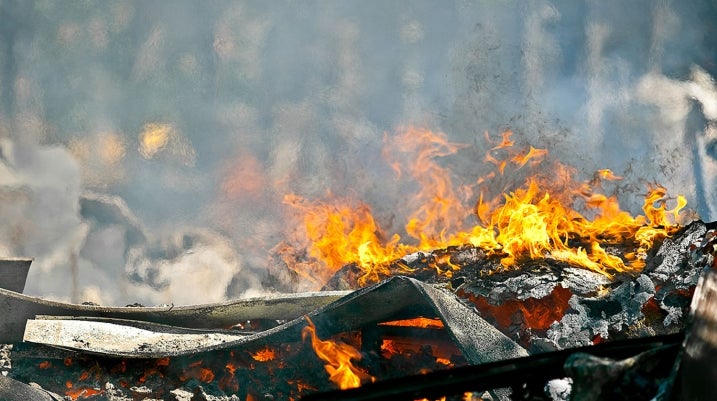 House rubble on fire